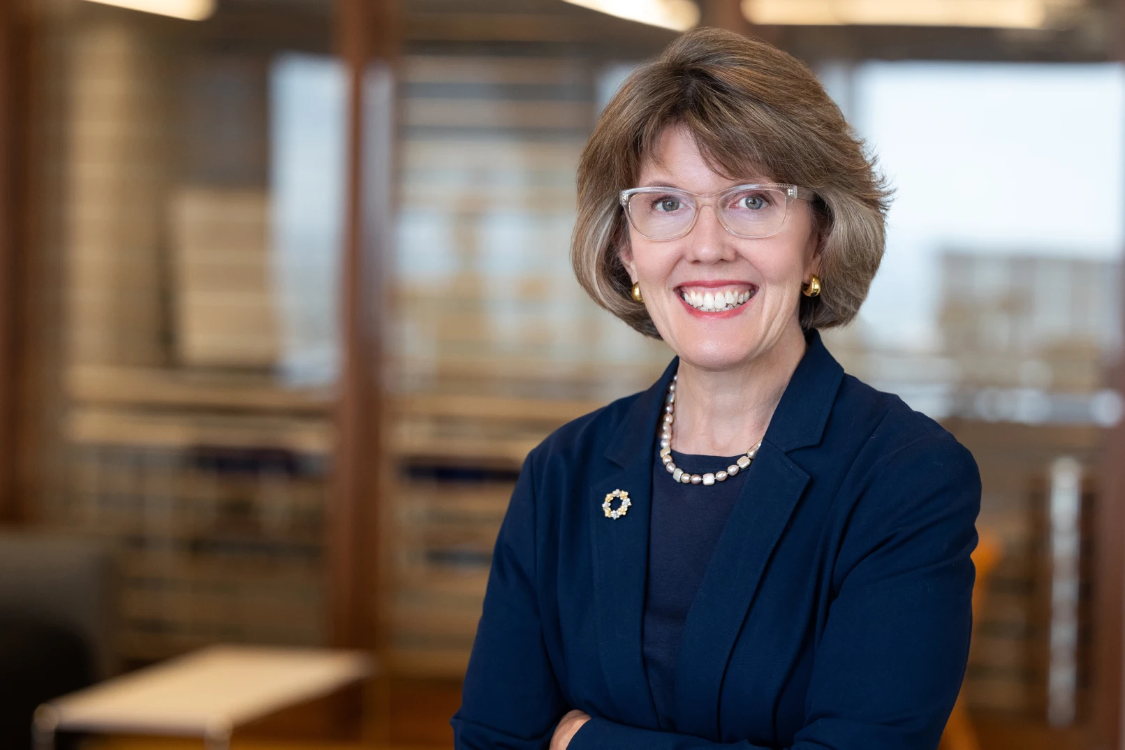 Professional woman smiling in an office setting.