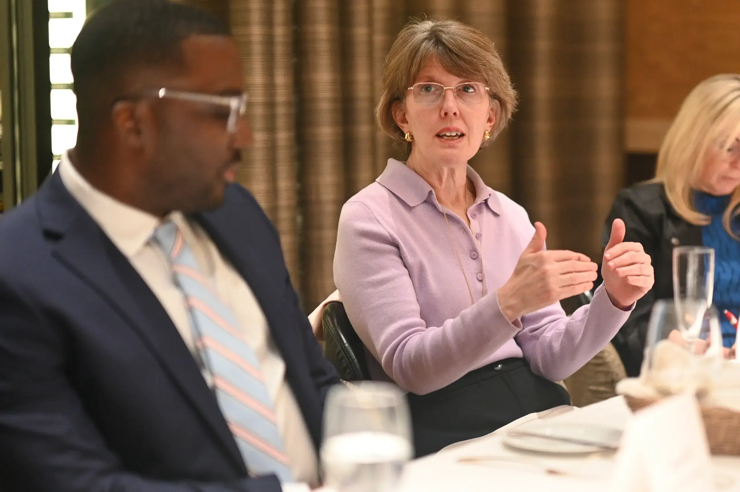 People discussing at a conference table.